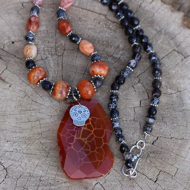 Red agate stone pendant necklace with a sugar skull charm